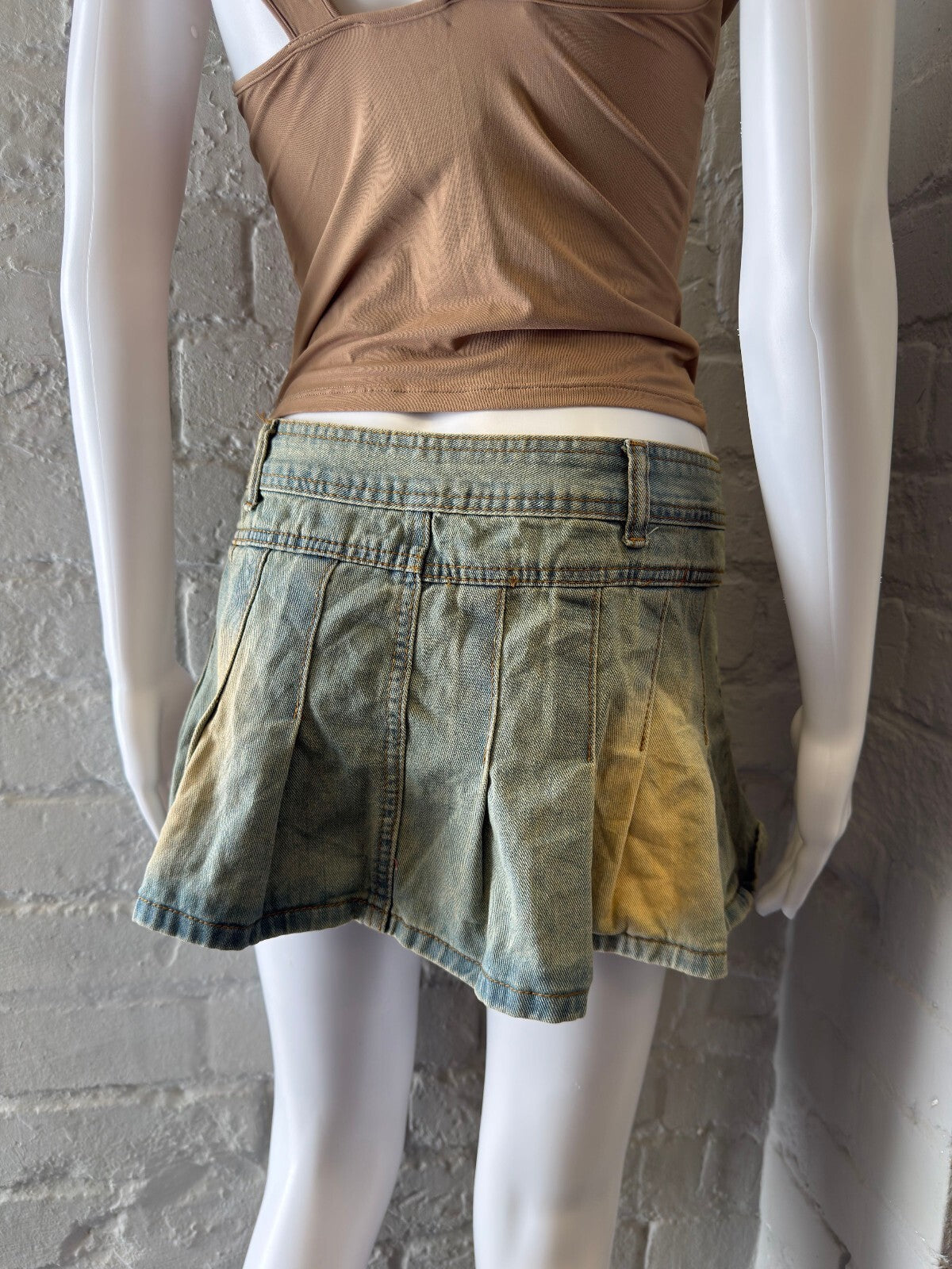 Pleated Denim Mini Skirt with Faded Yellow Accents